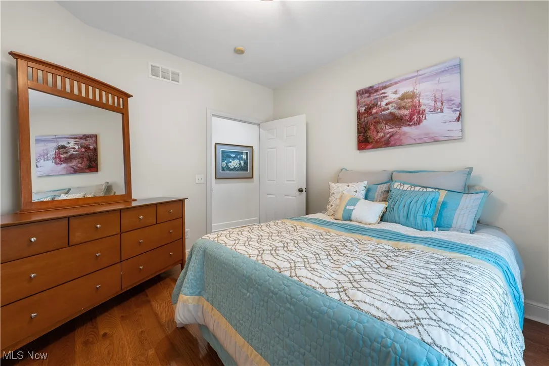 Bedroom featuring dark wood-style flooring and baseboards