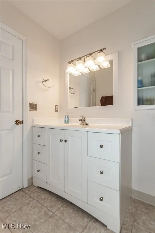 Bathroom with vanity and light tile patterned floors