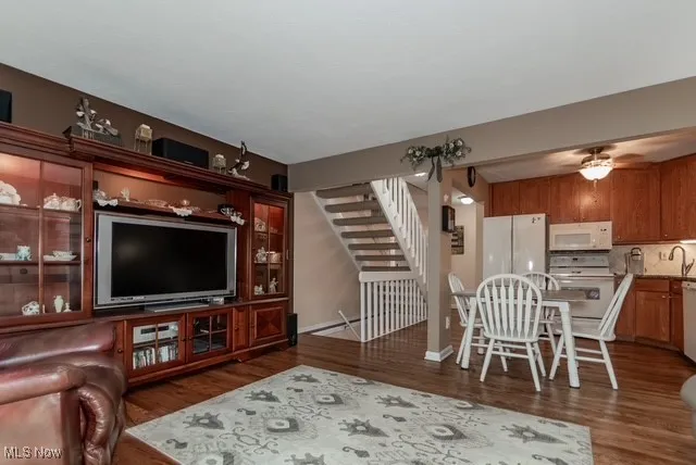 Living room with dark wood-style flooring and stairway