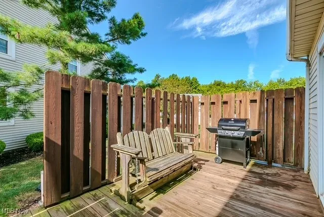 Wooden deck featuring area for grilling
