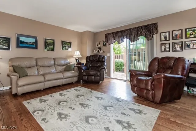 Living room with dark wood-type flooring