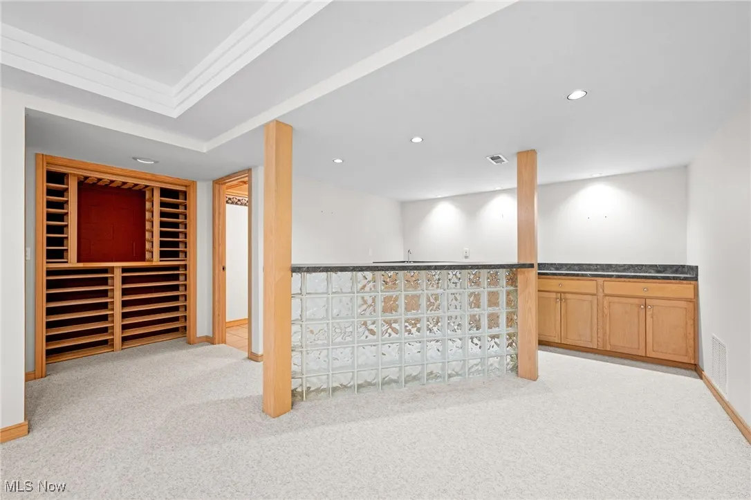 Finished below grade area with light carpet and recessed lighting