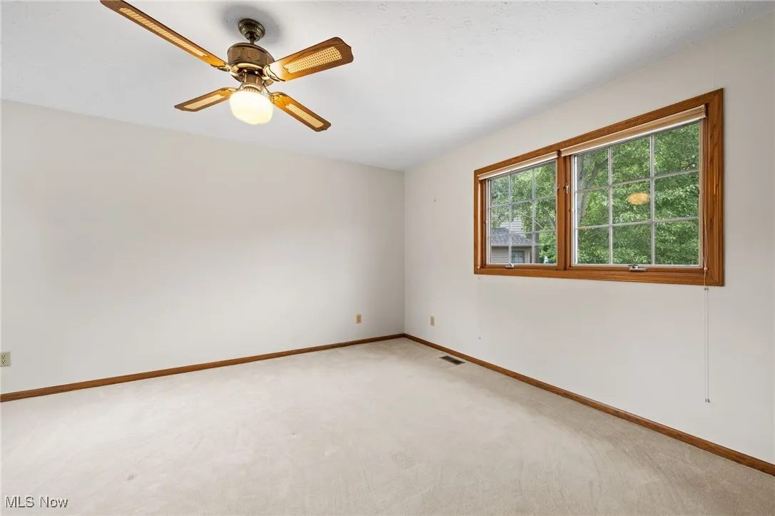 Second floor primary  bedroom with carpet flooring and ceiling fan