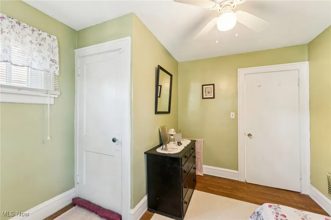 Foyer with wood finished floors and ceiling fan