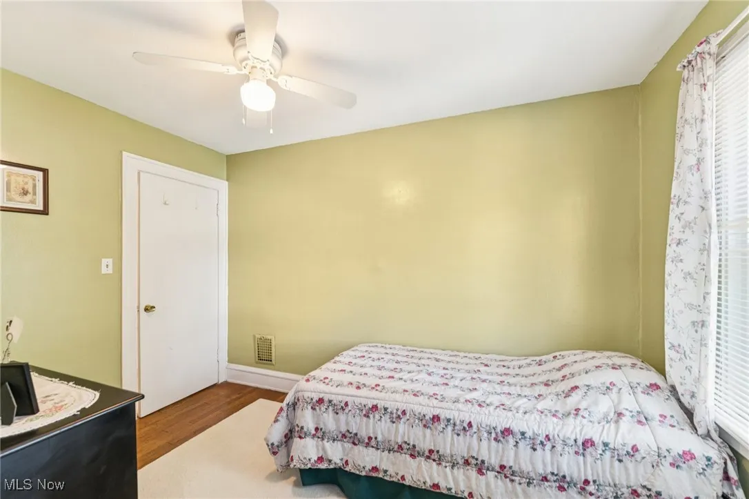 Bedroom with wood finished floors and ceiling fan