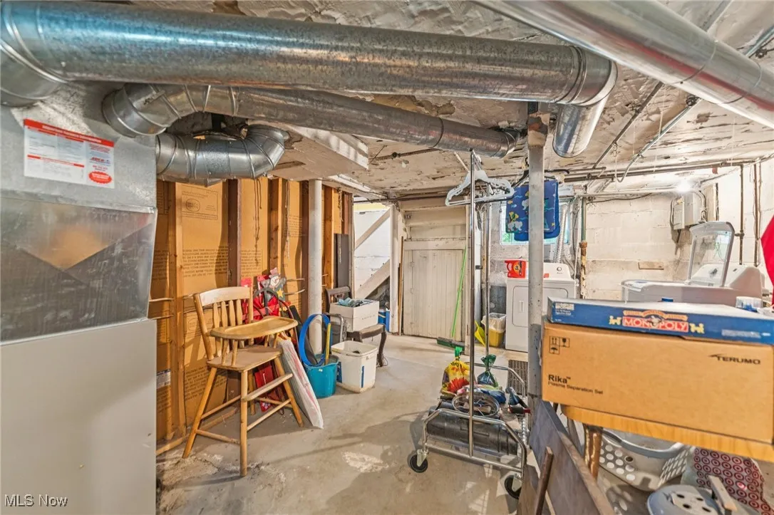 Unfinished below grade area with washer / dryer and heating unit