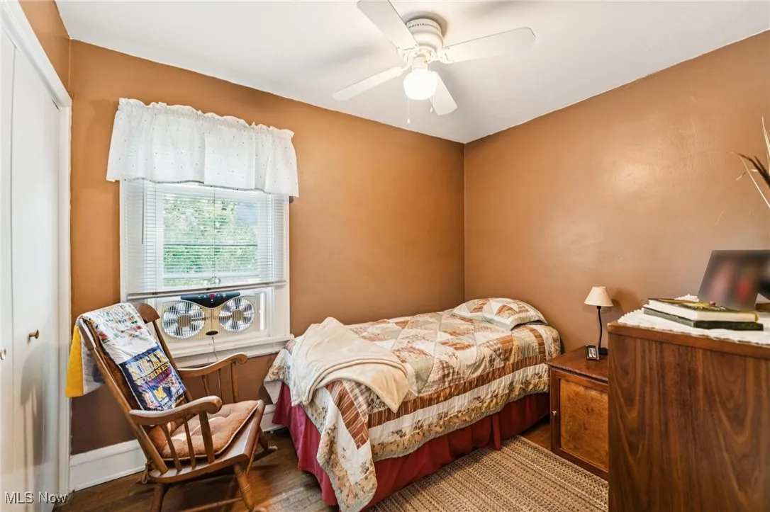 Bedroom with a closet, ceiling fan, and wood finished floors