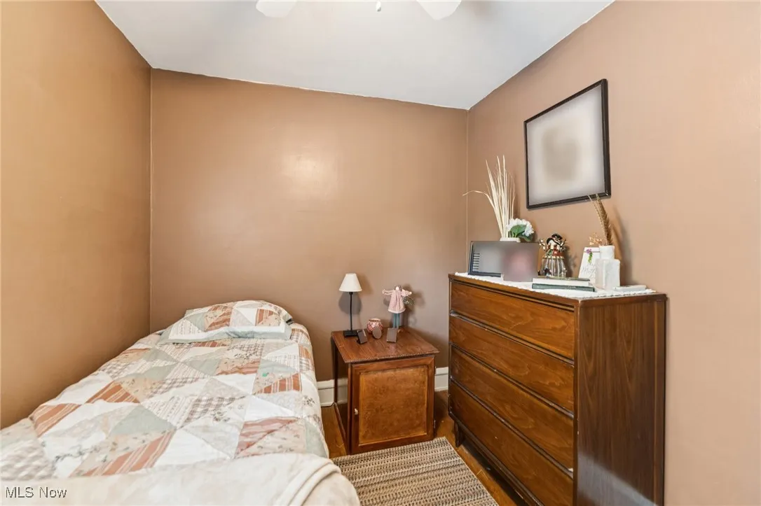Bedroom featuring wood finished floors and ceiling fan