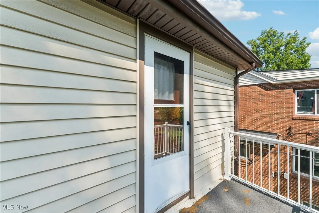 Entrance to property with brick siding