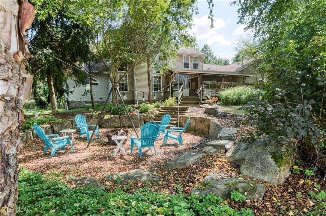 View of yard featuring an outdoor fire pit and stairway