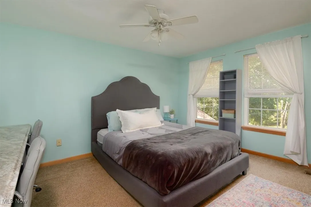 Bedroom with carpet and a ceiling fan