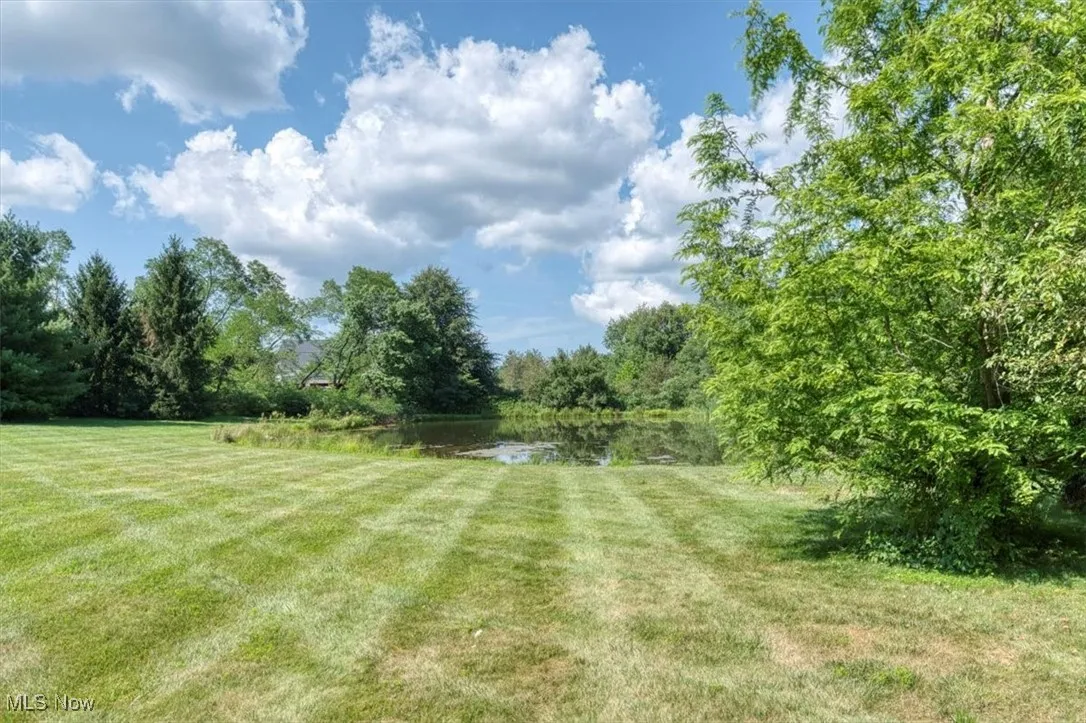 View of green lawn featuring a water view