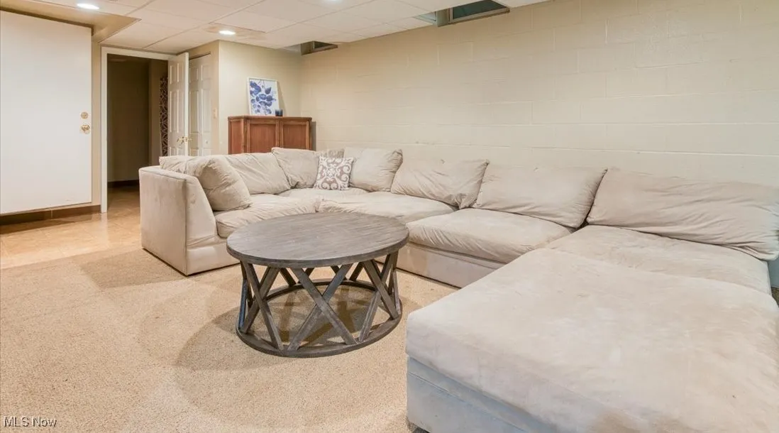 Living room featuring a paneled ceiling and recessed lighting