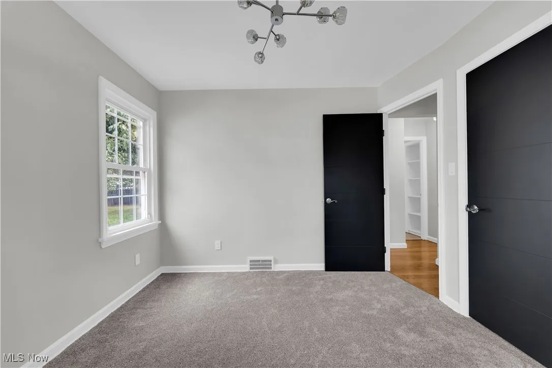 Unfurnished bedroom featuring carpet floors and baseboards