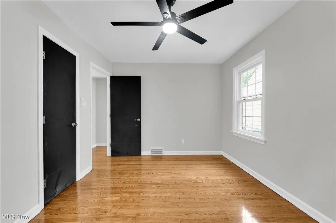 Unfurnished bedroom featuring light wood finished floors and a ceiling fan