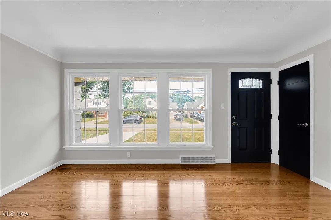 Foyer entrance with plenty of natural light and light wood-style floors