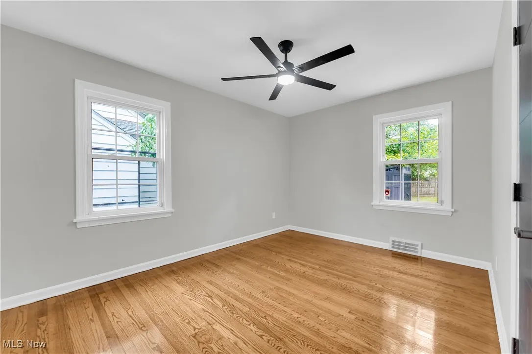 Spare room with light wood-style flooring and a ceiling fan