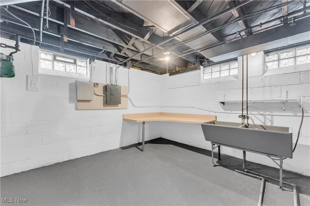 Below grade area featuring electric panel and healthy amount of natural light