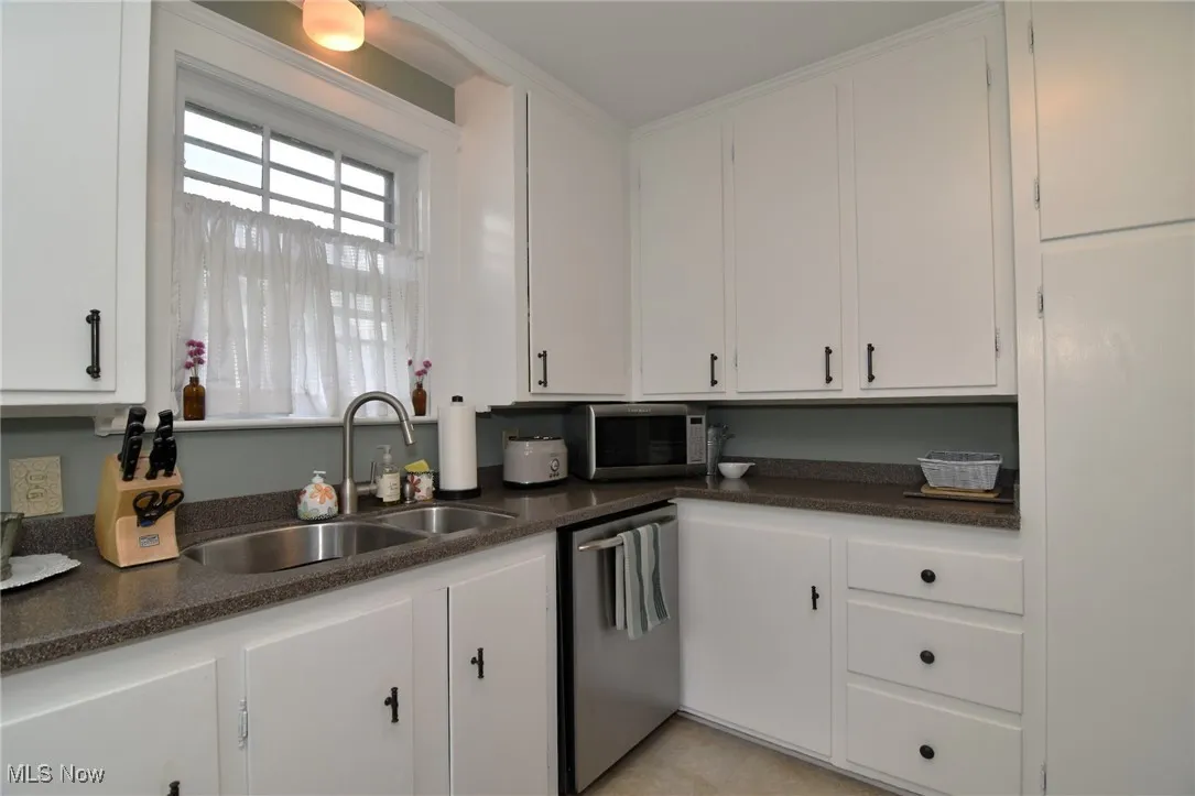 Kitchen featuring white cabinetry and stainless steel appliances