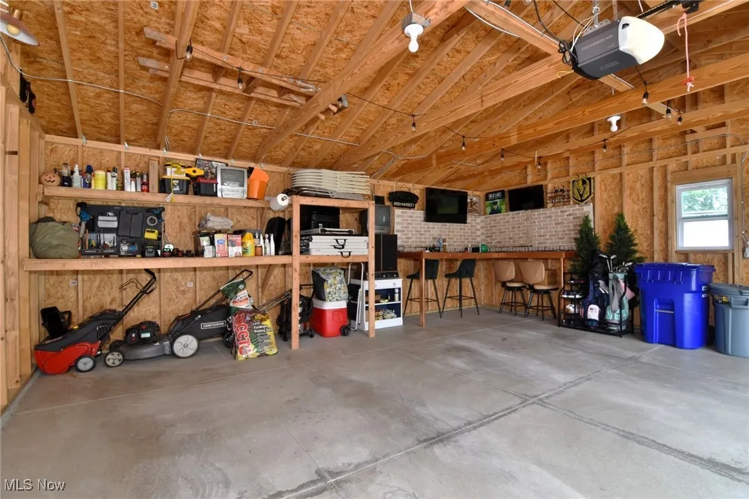Garage featuring a garage door opener and a workshop area