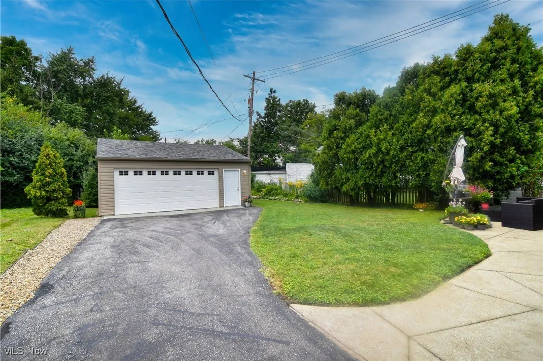 View of yard featuring an outdoor structure and a garage