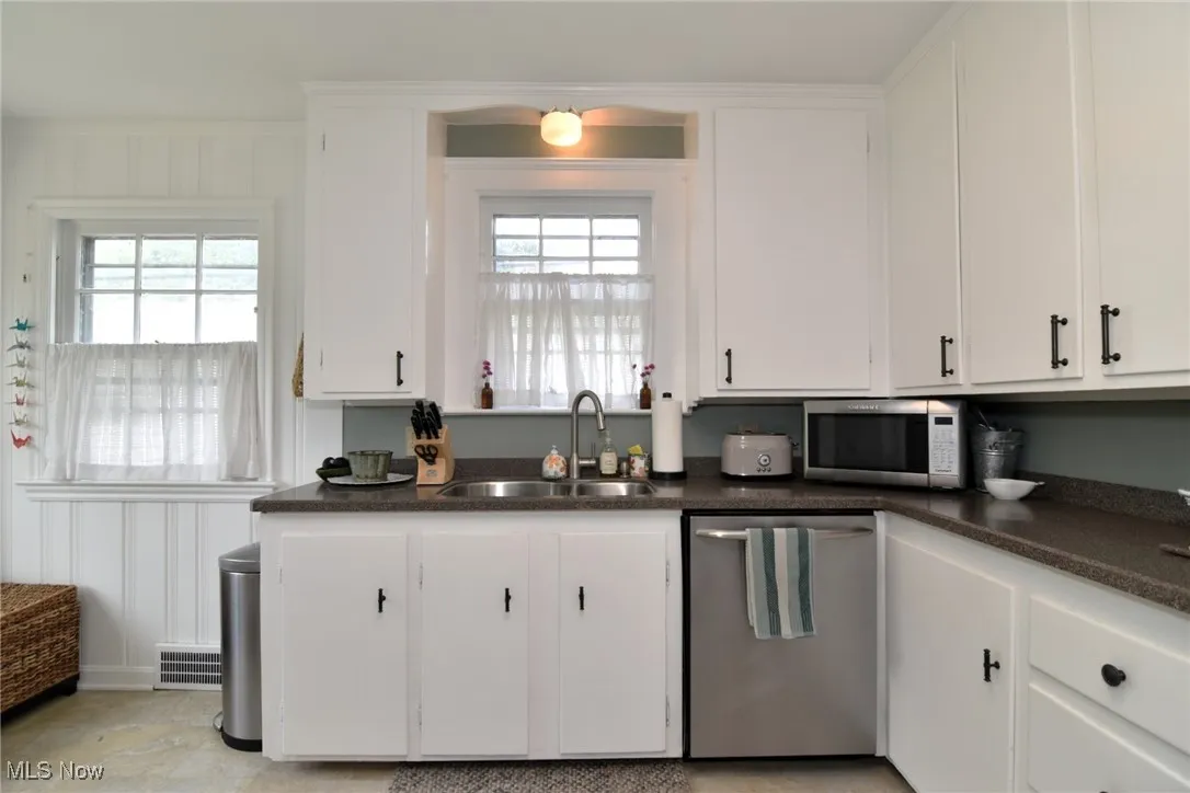 Kitchen featuring white cabinetry and stainless steel appliances