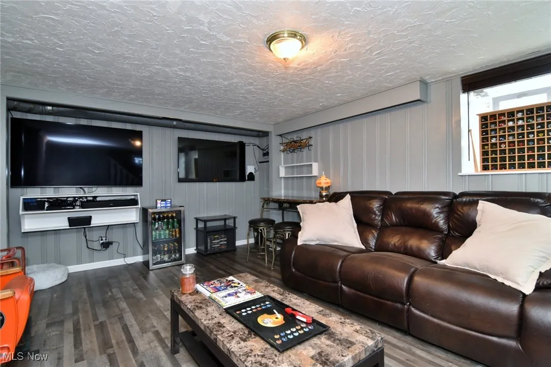 Living room featuring dark wood finished floors and wine cooler