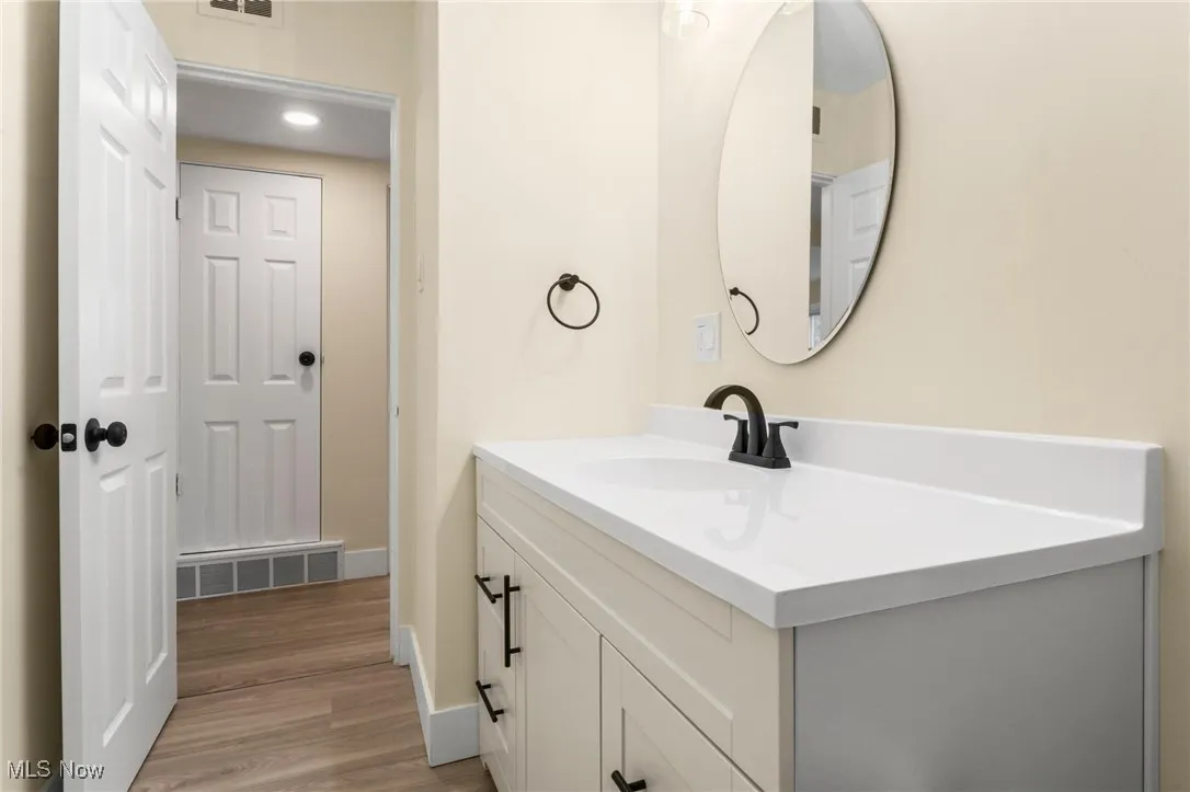 Bathroom with vanity and wood finished floors