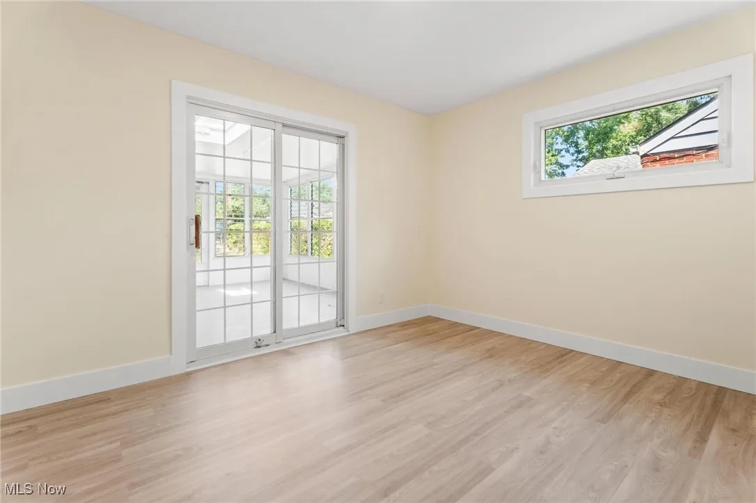 Unfurnished room with baseboards and light wood-style floors