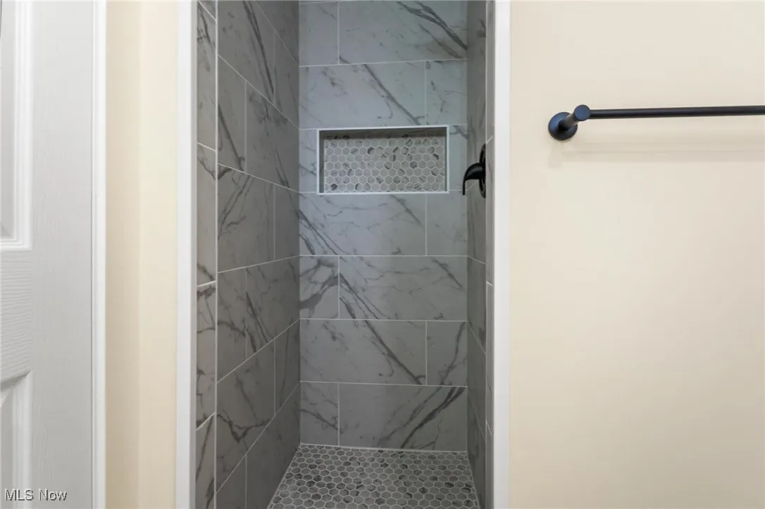 Bathroom featuring a tile shower