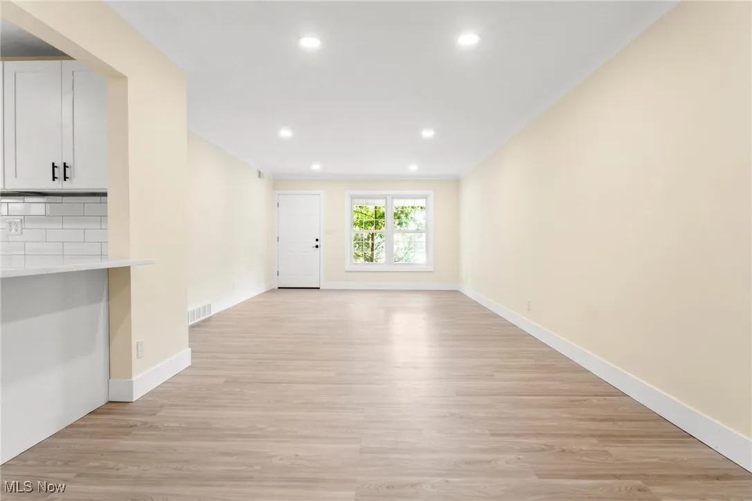 Unfurnished living room featuring light wood-style flooring and recessed lighting