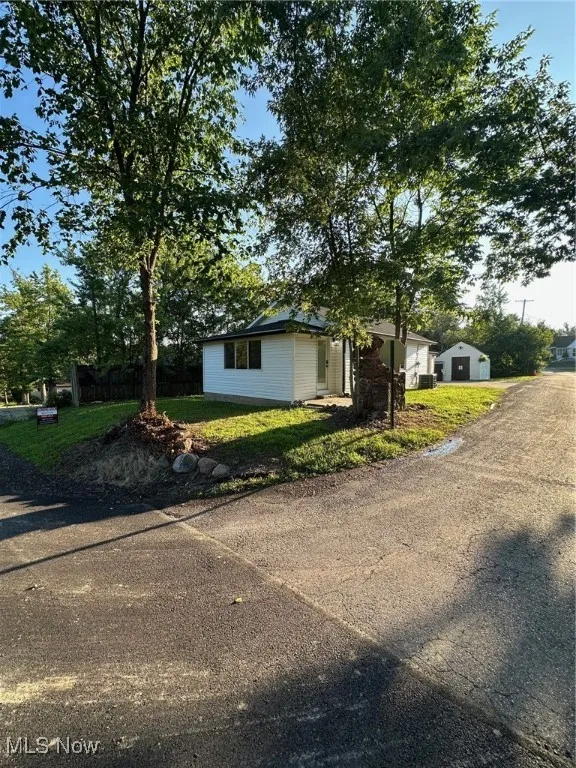 Corner lot view with door and patio, bus stop area is here, can wait inside for bus