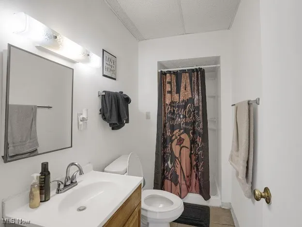 Bathroom featuring vanity, a shower stall, and light tile patterned floors