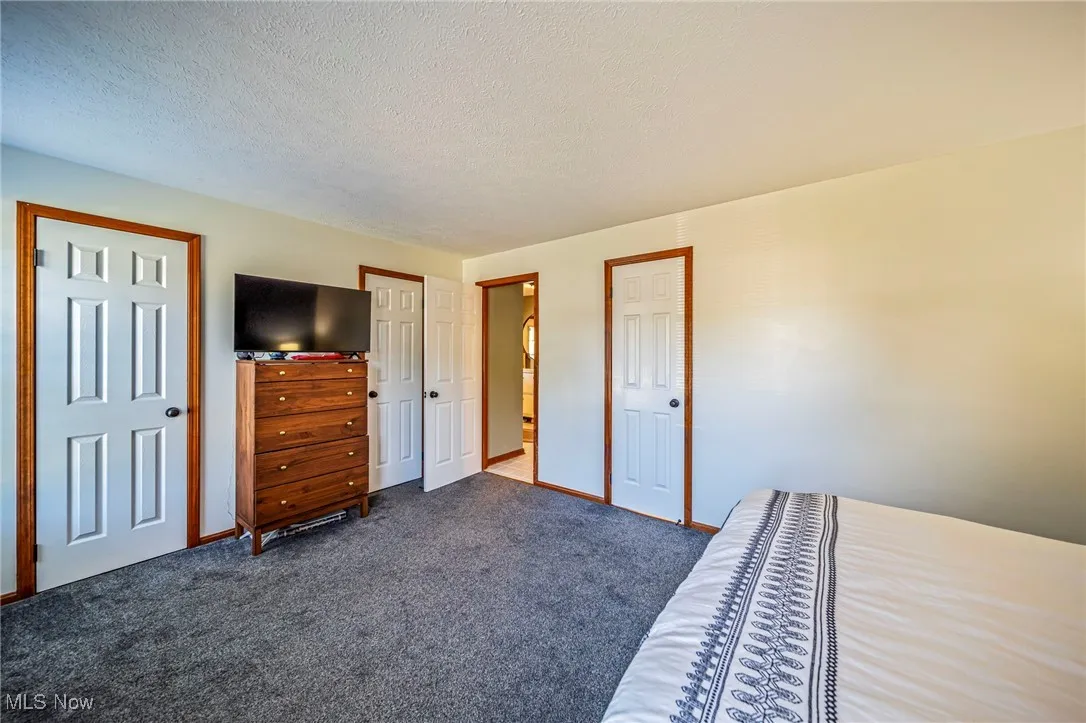 Master bedroom with two walk in closets (left and right of dresser).