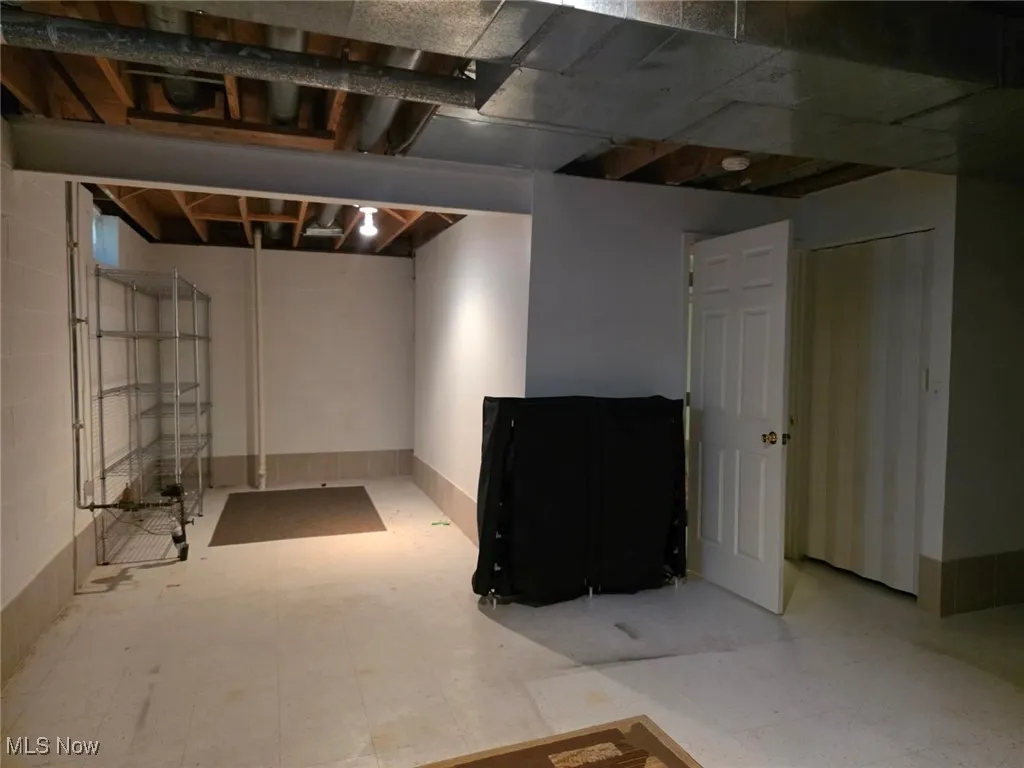Unfinished below grade area featuring tile patterned floors