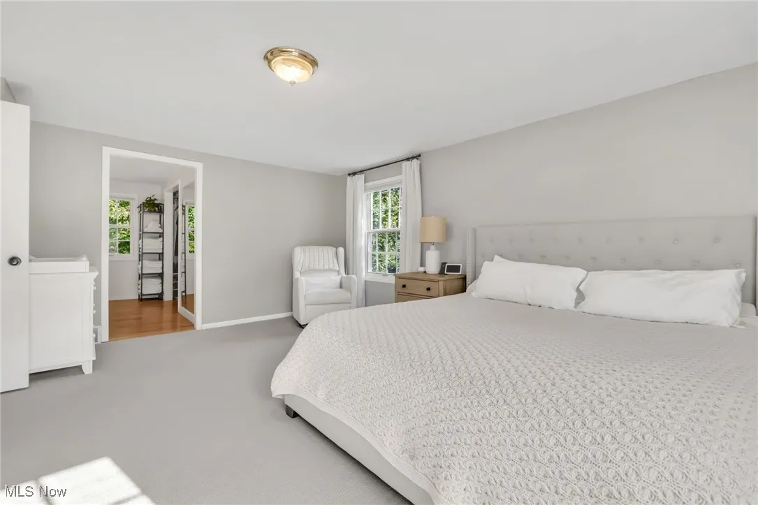 Bedroom featuring baseboards and carpet