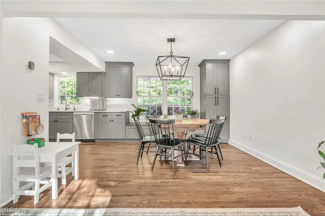 Dining space with light wood-style flooring, plenty of natural light, a chandelier, and recessed lighting