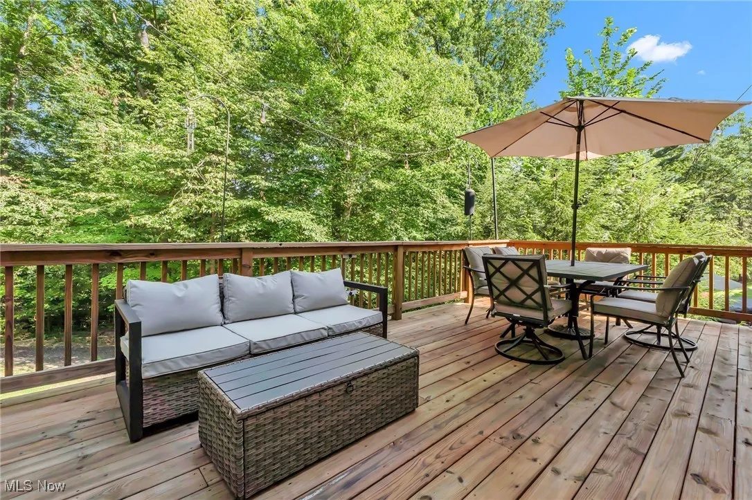 Wooden terrace featuring outdoor lounge area and outdoor dining area