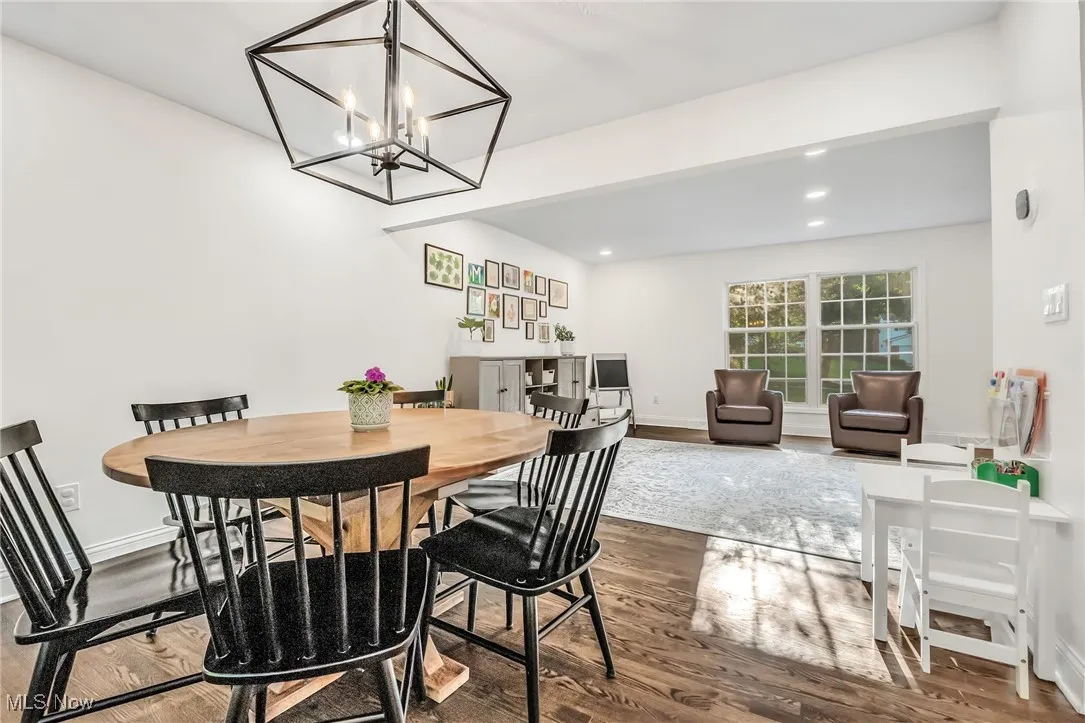 Dining area featuring wood finished floors, recessed lighting, and a chandelier