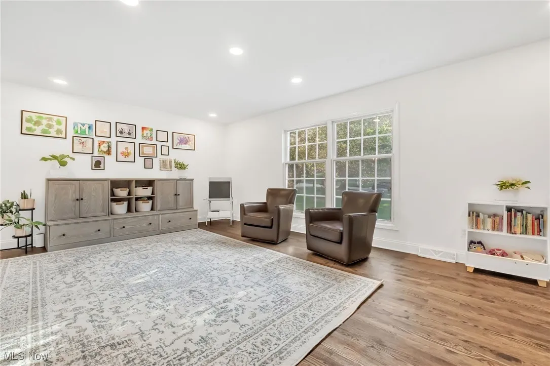 Sitting room with wood finished floors and recessed lighting