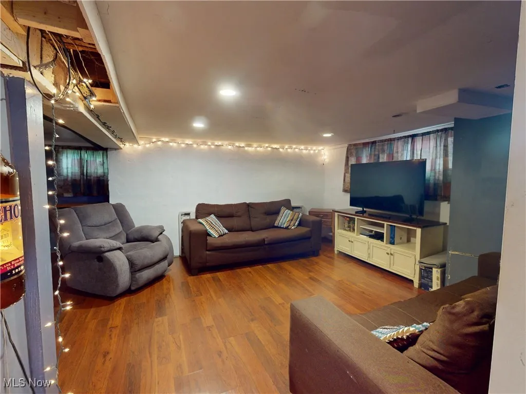 Living room with wood finished floors and recessed lighting
