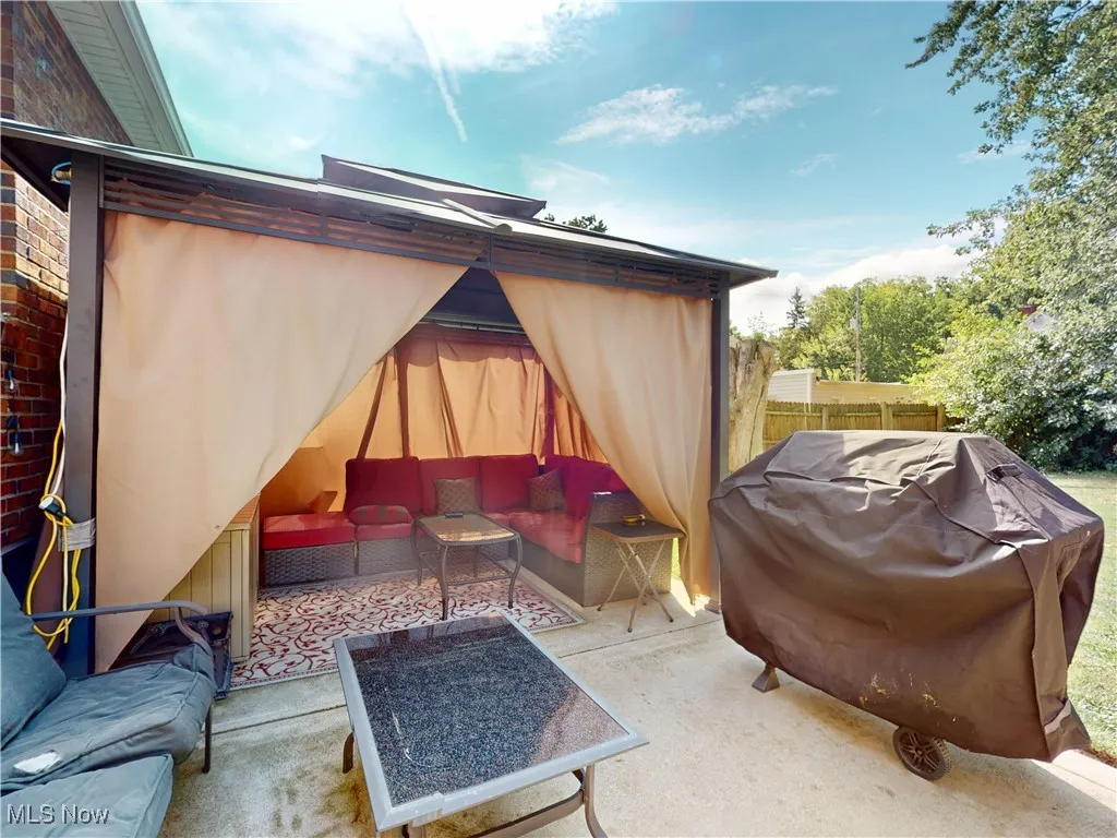 View of patio featuring a grill, an outdoor living space, and a gazebo