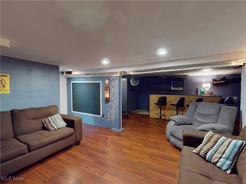 Living room with wood finished floors and recessed lighting