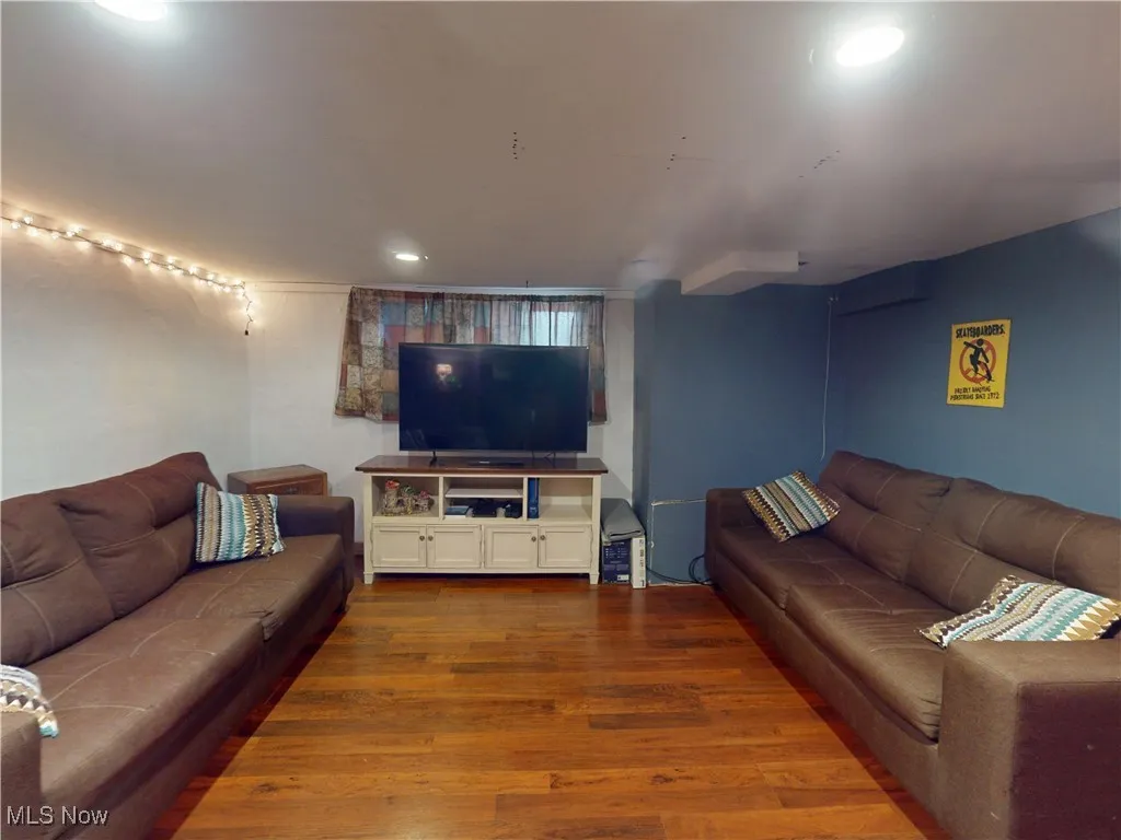 Living room with wood finished floors and recessed lighting