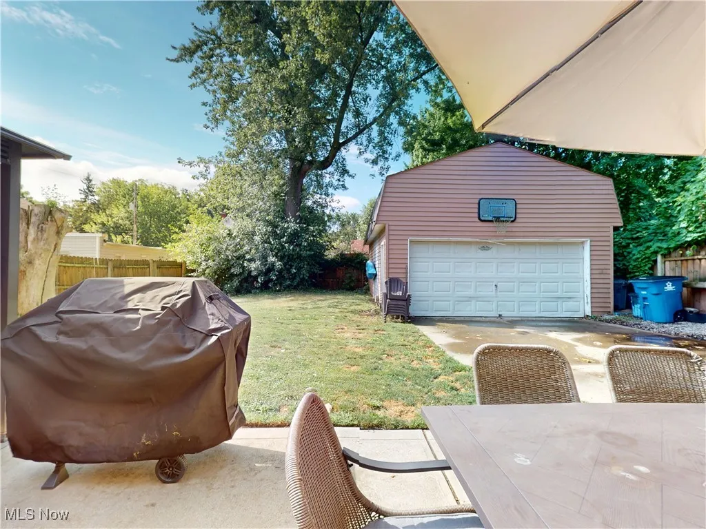 View of yard with a garage and an outdoor structure