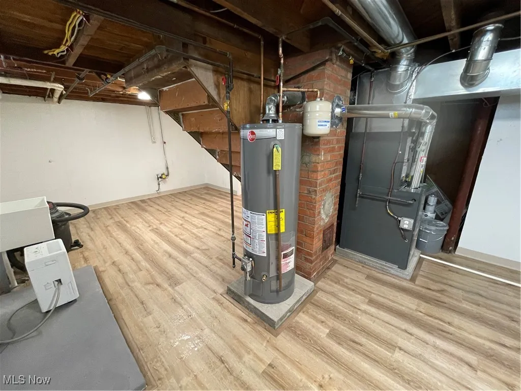 Utility room with gas water heater and heating unit