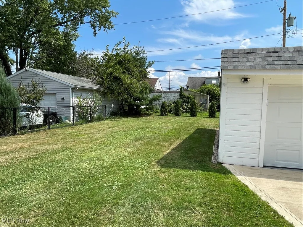 View of yard featuring an outbuilding and a garage