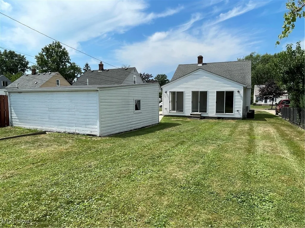 Back of house with a chimney