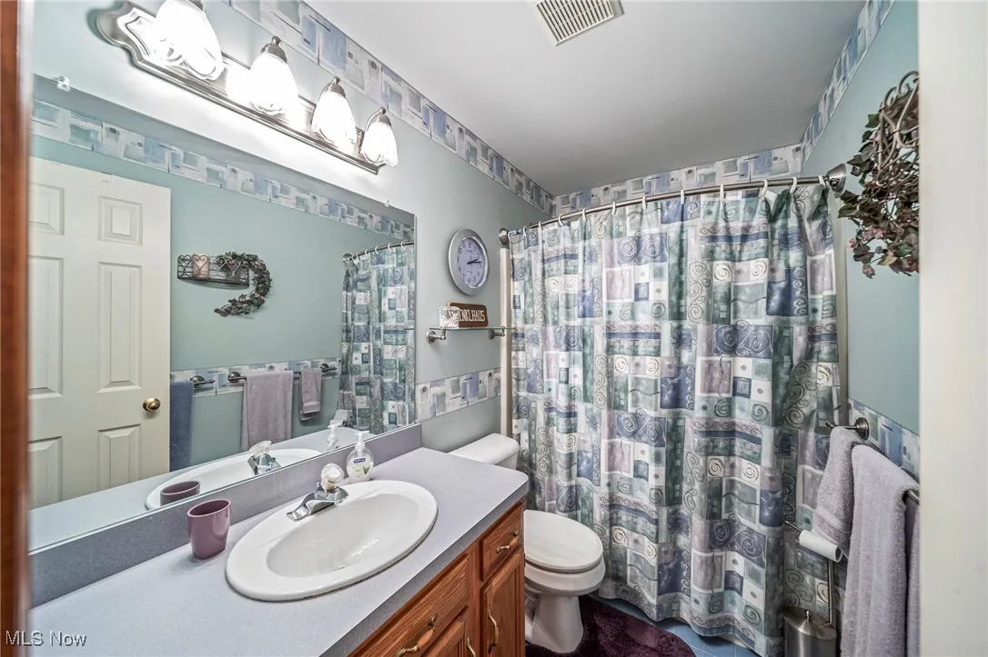 Full bath featuring vanity and a shower with curtain