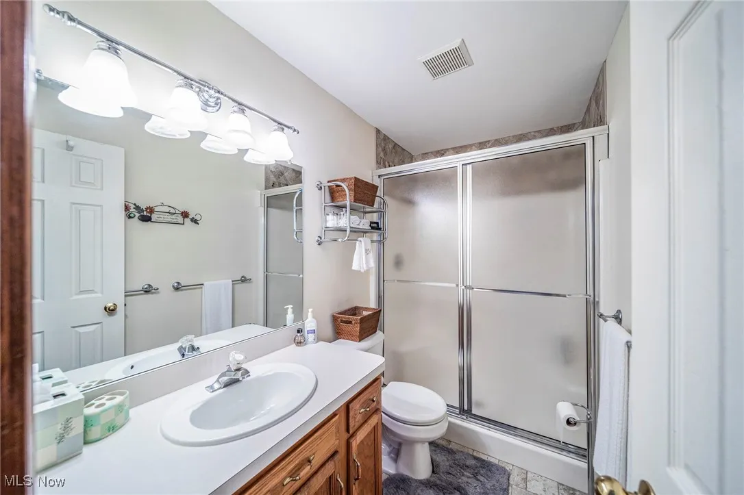 Bathroom with a shower stall and vanity